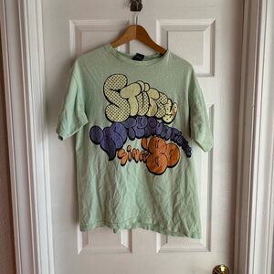 **Vintage** Stussy Green Short Sleeve Tee with Vibrant Graphic Design